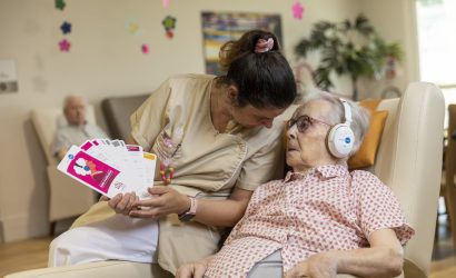 Résidente accompagnée par résidente écoute de la musique avec un casque les oreilles